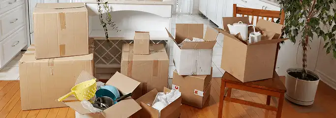 Packed moving boxes and household items in a kitchen before move-out or move-in cleaning, Detroit, MI.